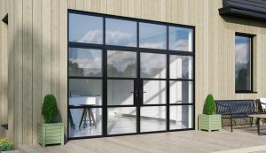 Black-framed double glass doors with a matching large transom window above, set into light wood vertical siding.